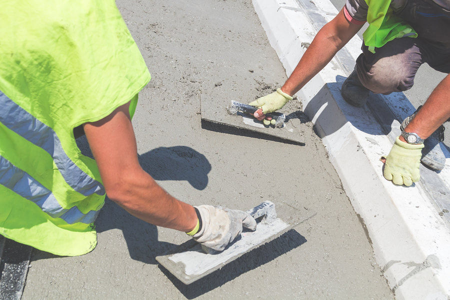 professional concrete workers working on concrete stamping 