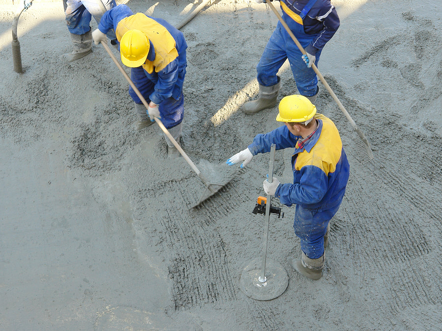 professional concrete workers working on concrete foundation 