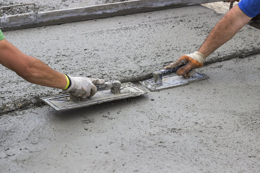 professional concrete worker working on concrete sidewalks